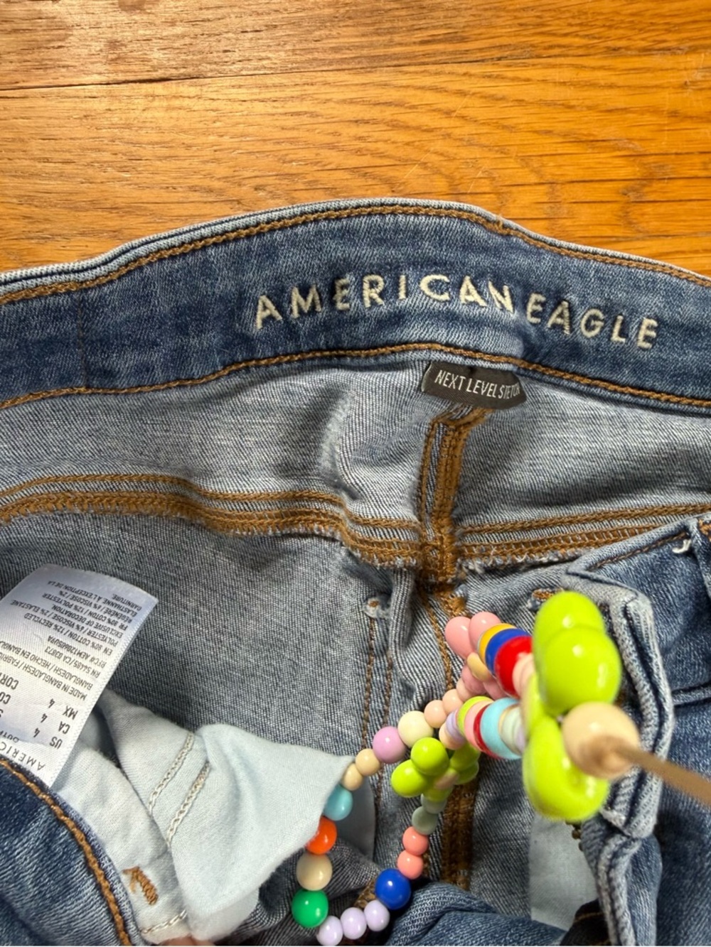 American Eagle Outfitters High-Rise Light Blue Jeans with Beaded Charm